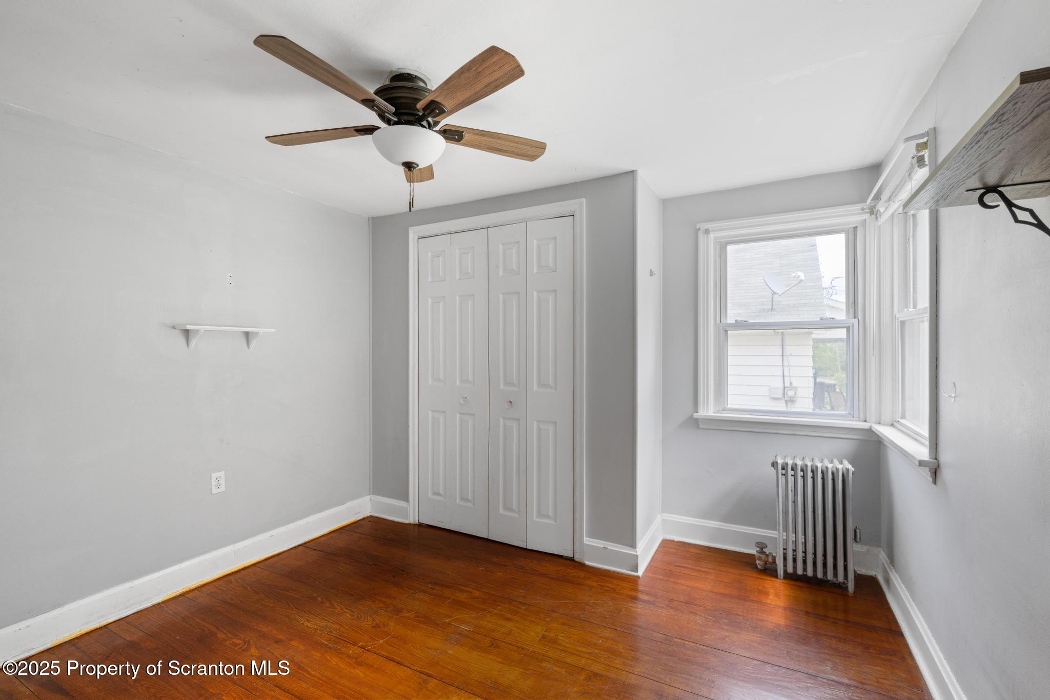 730 Chase Road Shavertown, PA 18708 - Photo 30 of 43 an empty room with wooden floor chandelier fan and windows