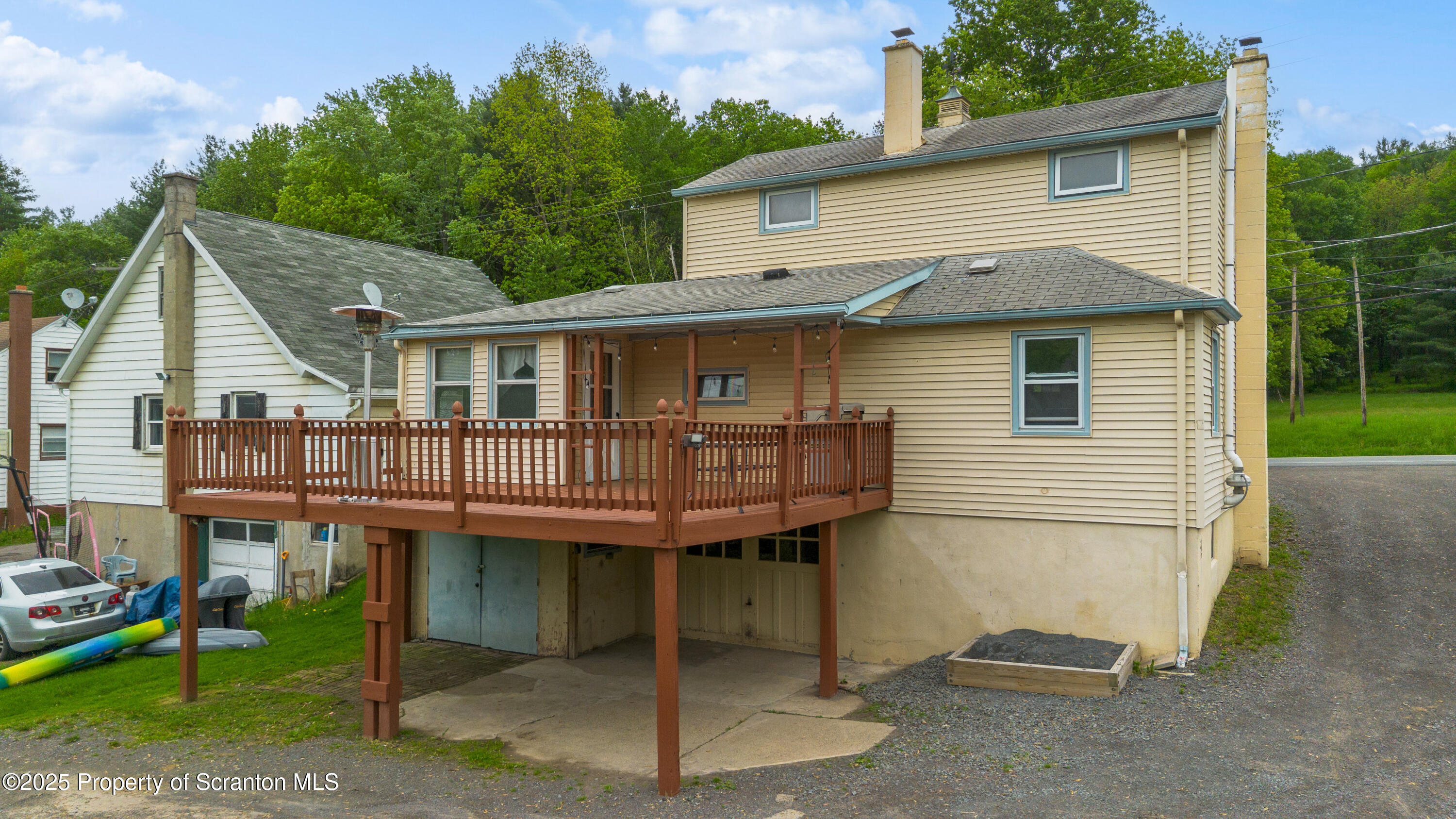 730 Chase Road Shavertown, PA 18708 - Photo 8 of 43 a view of a white house with large windows and a small yard