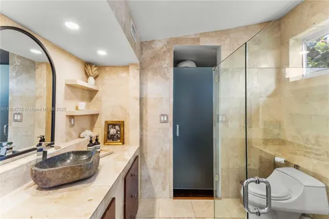 a bathroom with a double vanity sink mirror and shower