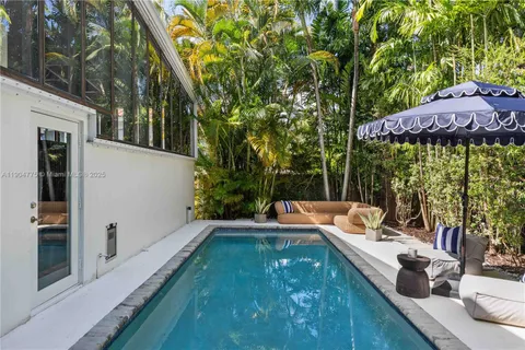 a view of a house with backyard sitting area and furniture