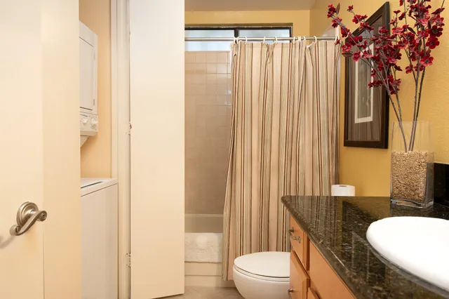 a bedroom with a bed dresser and window