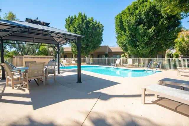 a swimming pool with outdoor seating yard and barbeque oven