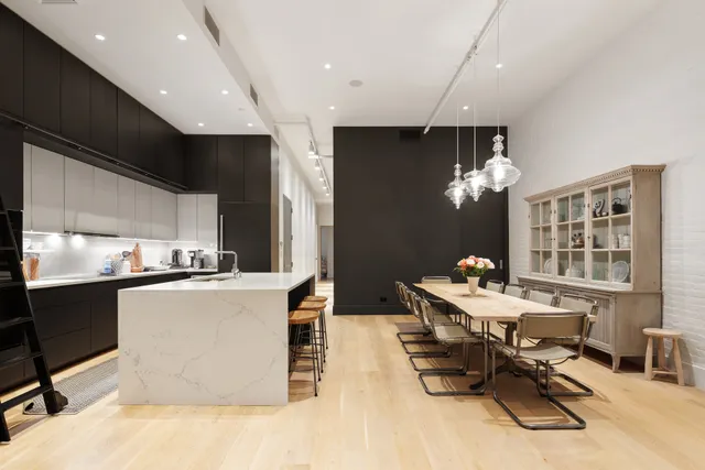 a kitchen with stainless steel appliances kitchen island granite countertop a sink and a stove