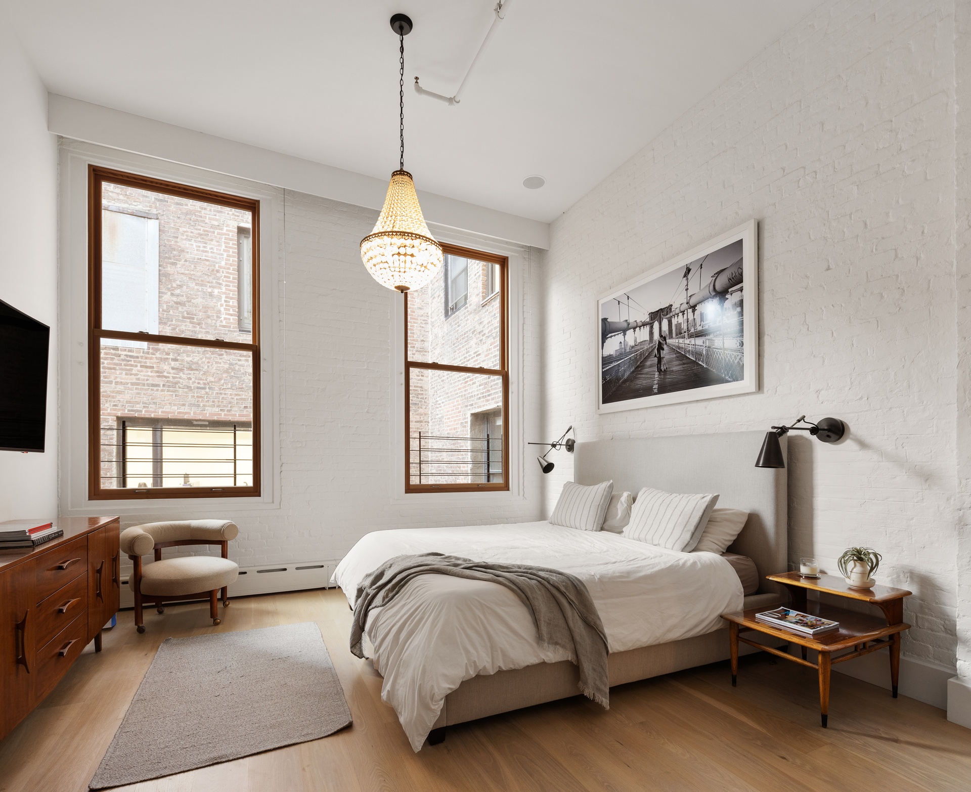 121 Mercer Street, Unit 4 Manhattan, NY 10012 - Photo 9 of 14 a spacious bedroom with a bed and a window