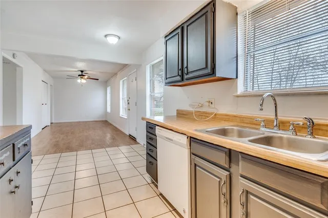 a kitchen with a sink a stove and cabinets