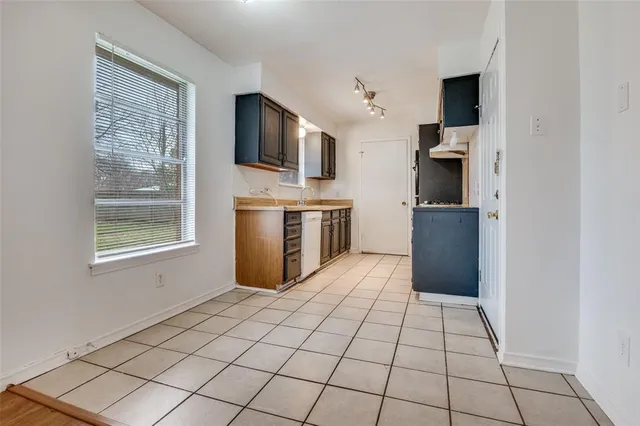 a kitchen with stainless steel appliances a refrigerator and a stove top oven