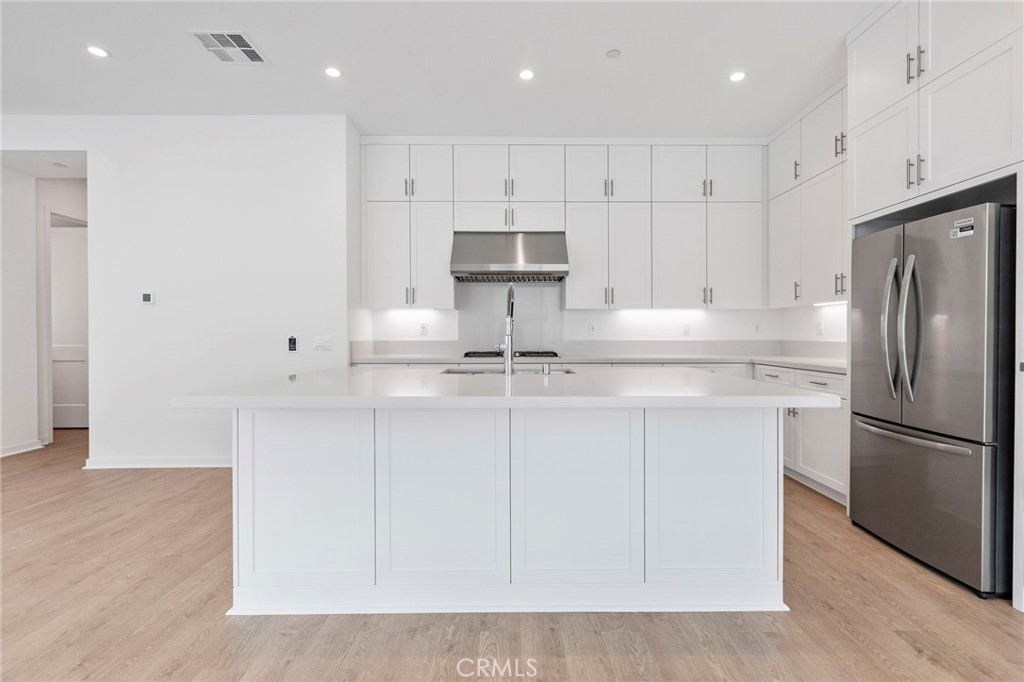 43 Miren Place Arcadia, CA 91007 - Photo 11 of 37 a kitchen with kitchen island white cabinets and stainless steel appliances