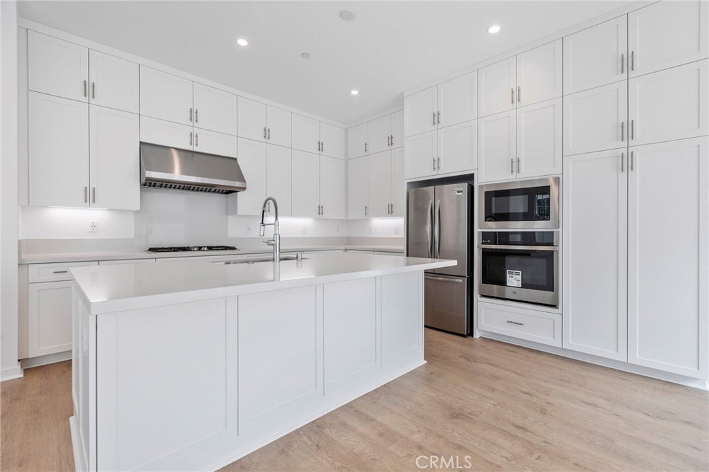 43 Miren Place Arcadia, CA 91007 - Photo 12 of 37 a kitchen with stainless steel appliances granite countertop a refrigerator oven a sink and white cabinets