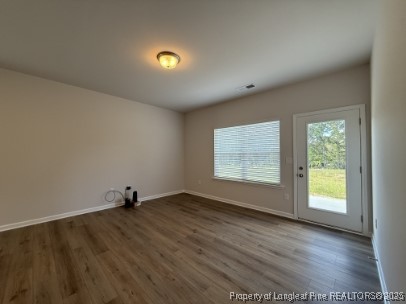274 Deodora Lane Cameron, NC 28326 - Photo 3 of 14 an empty room with wooden floor and windows