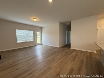 274 Deodora Lane Cameron, NC 28326 - Photo 4 of 14 an empty room with wooden floor and windows