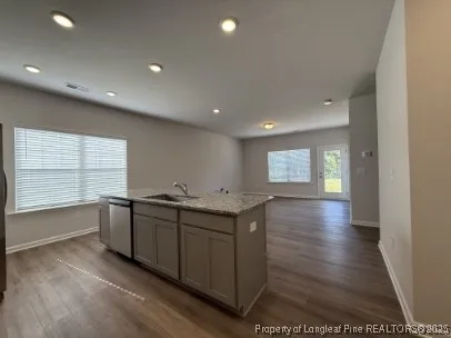 a kitchen with stainless steel appliances granite countertop a sink and a stove top oven