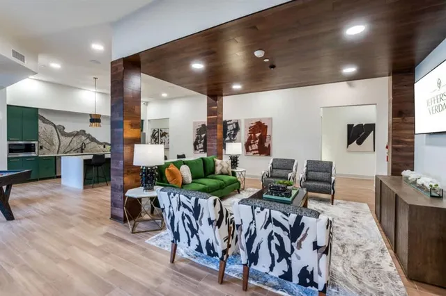 a living room with lots of furniture and kitchen view
