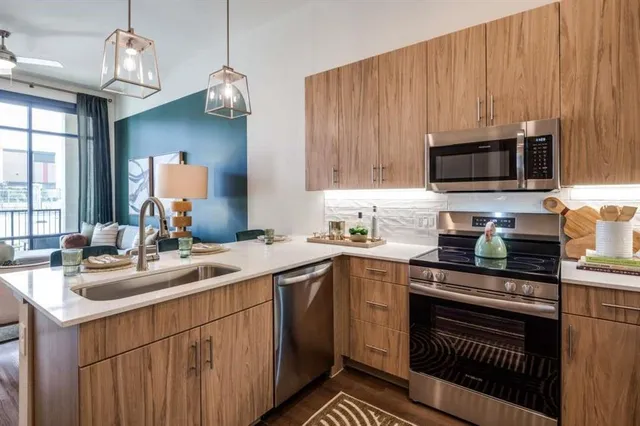 a kitchen with a sink and a stove top oven