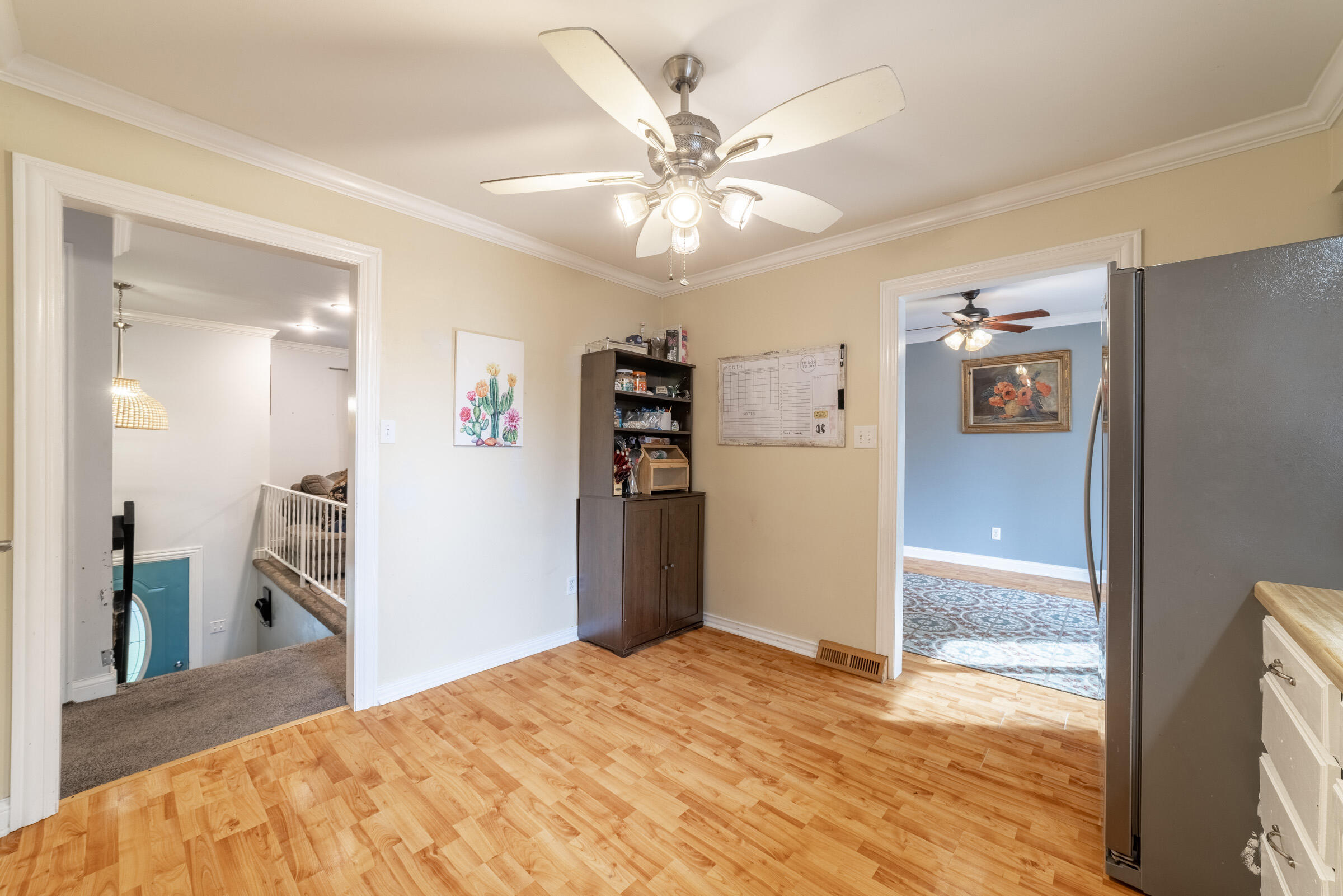 6331 Broughton Avenue Portage, IN 46368 - Photo 19 of 51 a view of a kitchen with a refrigerator and a ceiling fan