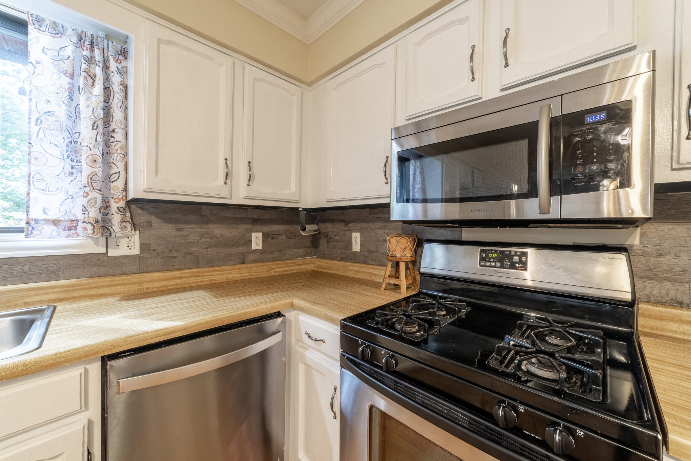 6331 Broughton Avenue Portage, IN 46368 - Photo 21 of 51 a kitchen with granite countertop a stove and a microwave