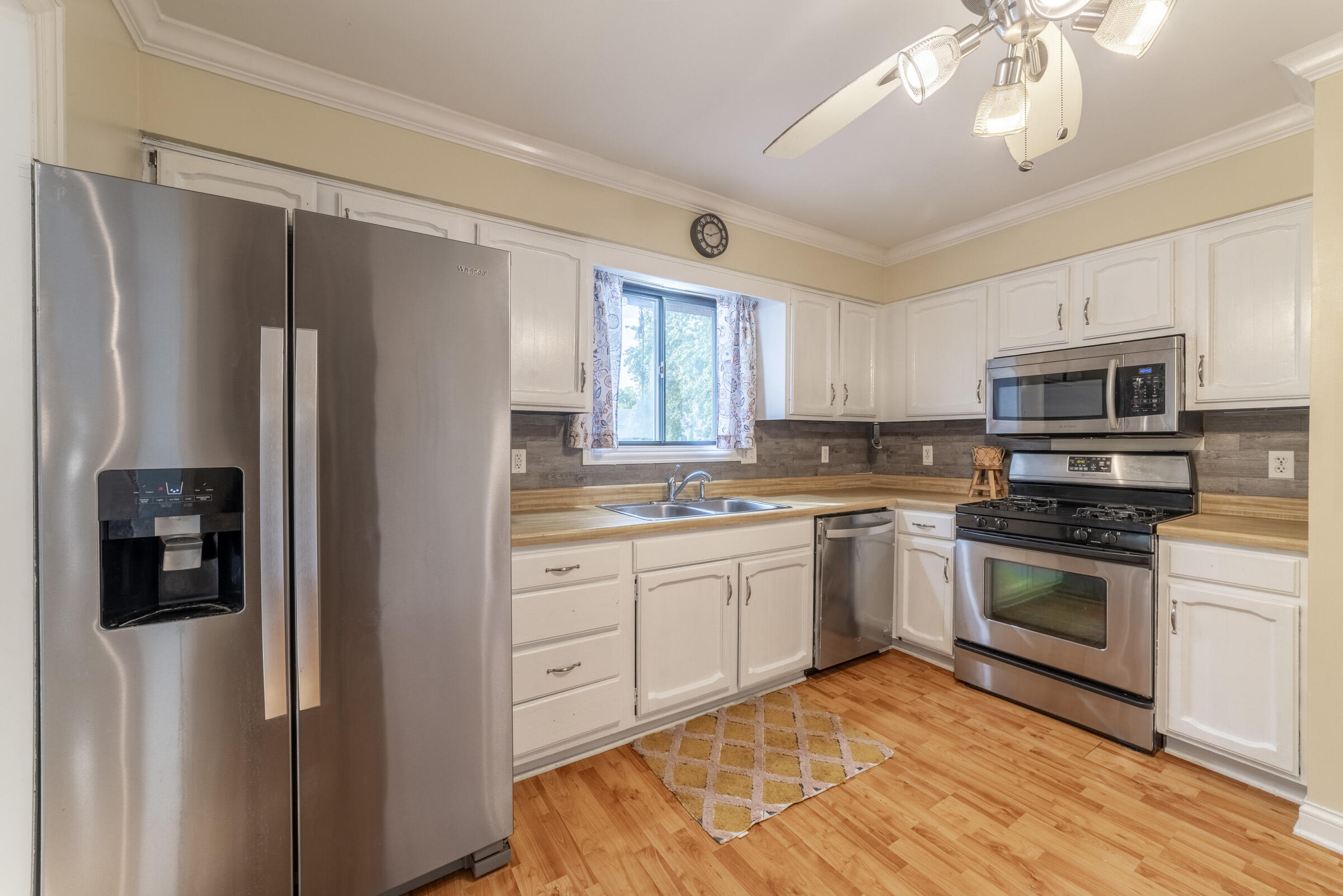 6331 Broughton Avenue Portage, IN 46368 - Photo 23 of 51 a kitchen with stainless steel appliances granite countertop a refrigerator a stove a sink and a microwave
