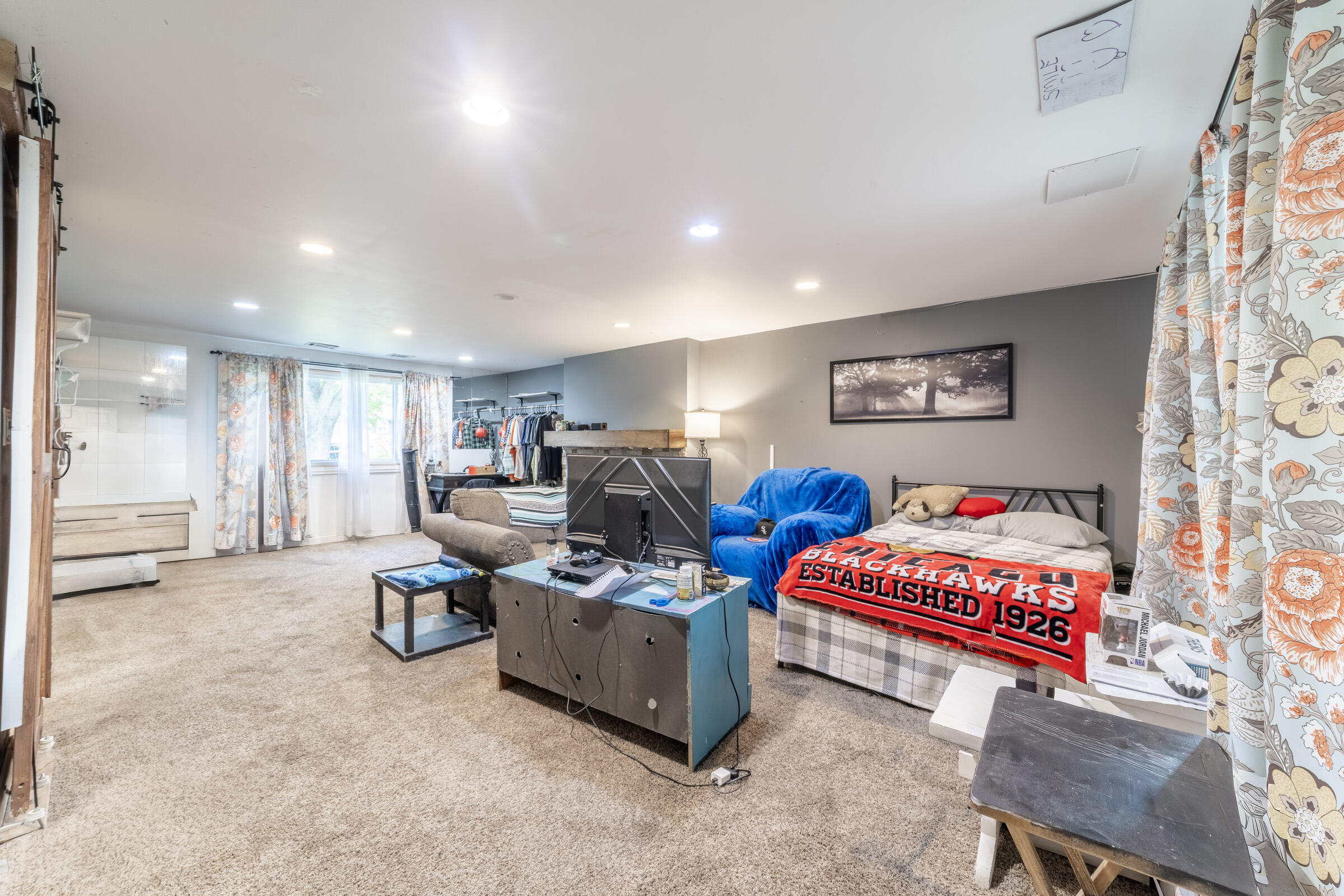 6331 Broughton Avenue Portage, IN 46368 - Photo 29 of 51 a living room with furniture a flat screen tv and gym equipment
