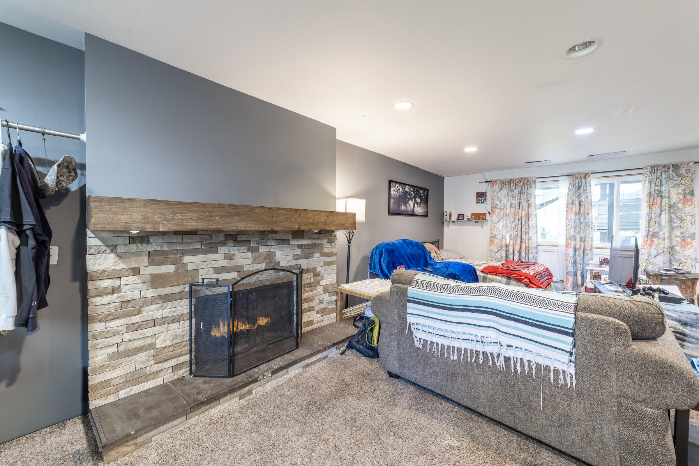 6331 Broughton Avenue Portage, IN 46368 - Photo 31 of 51 a living room with furniture a fireplace and a flat screen tv