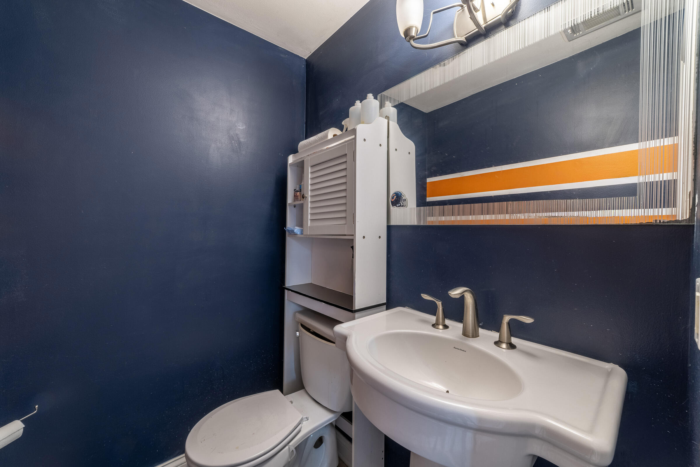 6331 Broughton Avenue Portage, IN 46368 - Photo 32 of 51 a bathroom with a sink a toilet and mirror