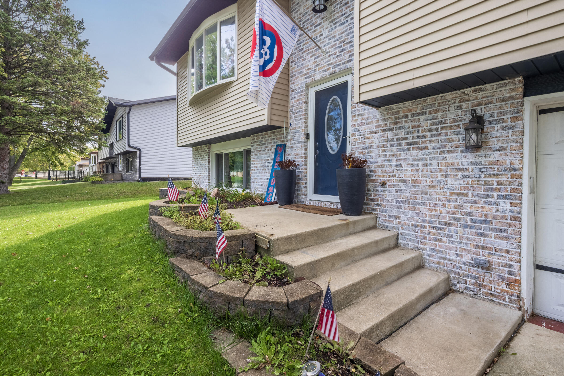 6331 Broughton Avenue Portage, IN 46368 - Photo 5 of 51 a front view of a house with garden and chairs