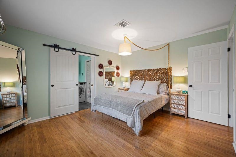 331 Holly Lane Erma, NJ 08204 - Photo 12 of 42 a bedroom with a bed and a chandelier