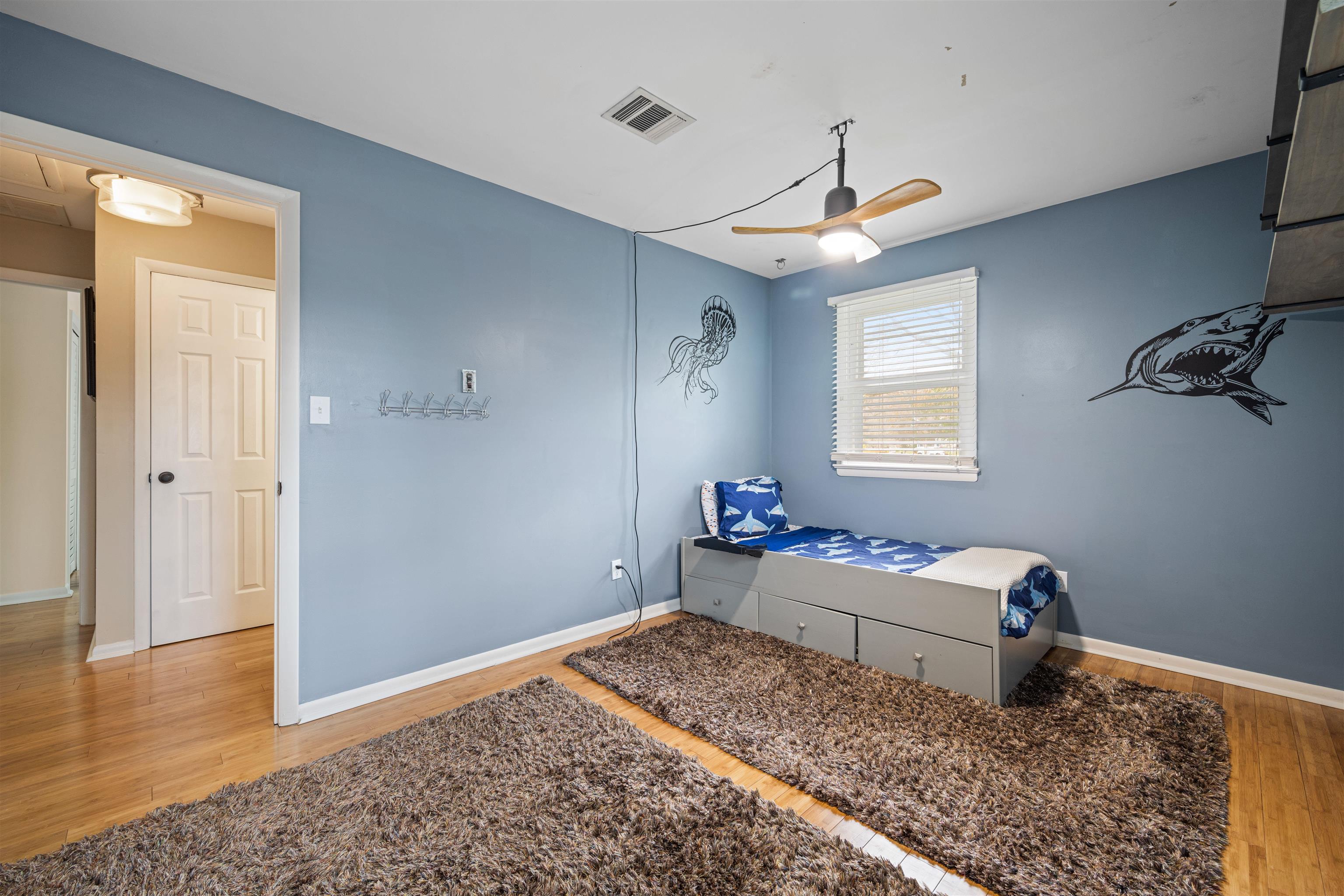 331 Holly Lane Erma, NJ 08204 - Photo 16 of 42 a bed room with a bed and a chandelier