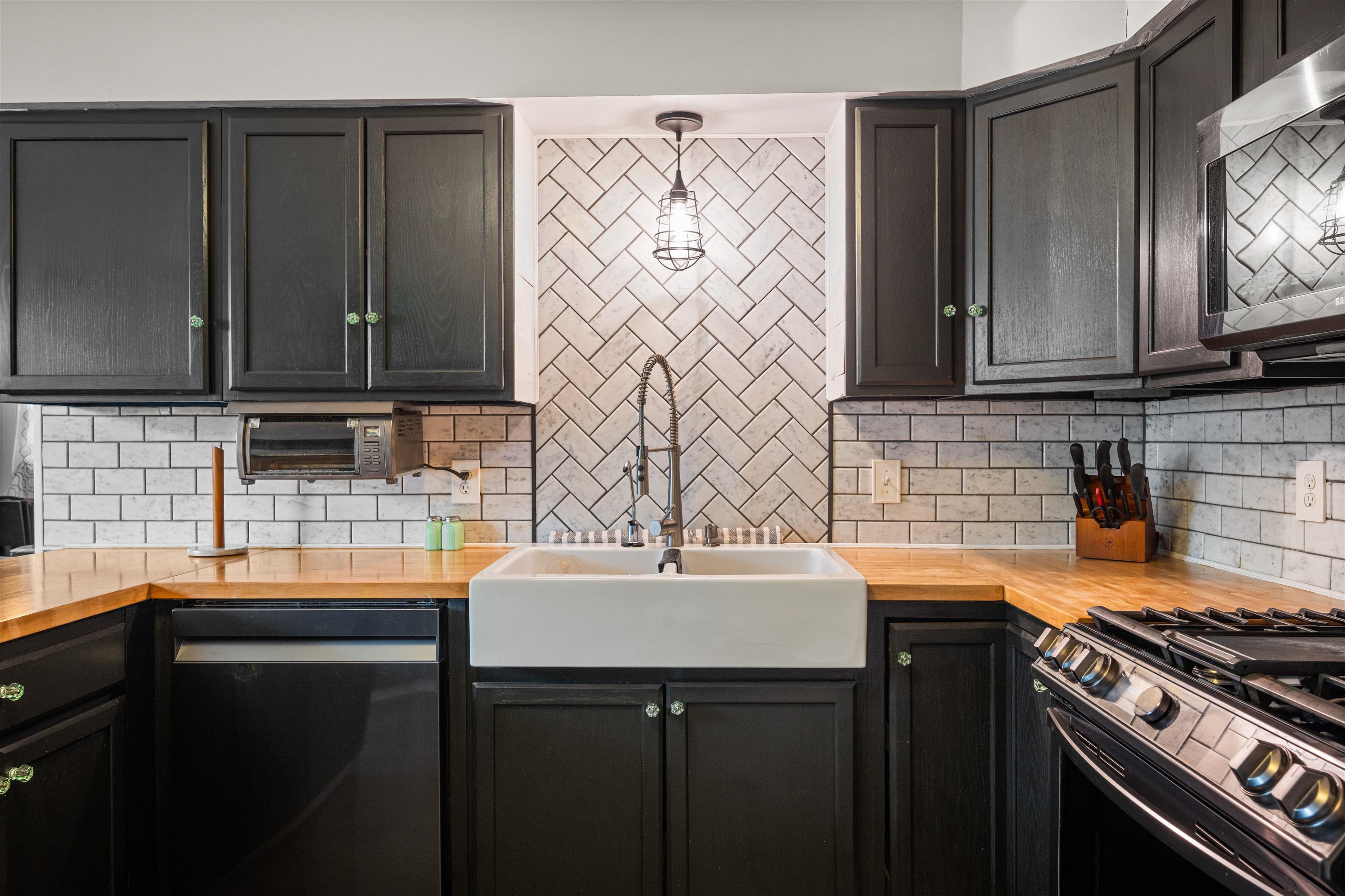 331 Holly Lane Erma, NJ 08204 - Photo 22 of 42 a kitchen with stainless steel appliances a sink stove and cabinets