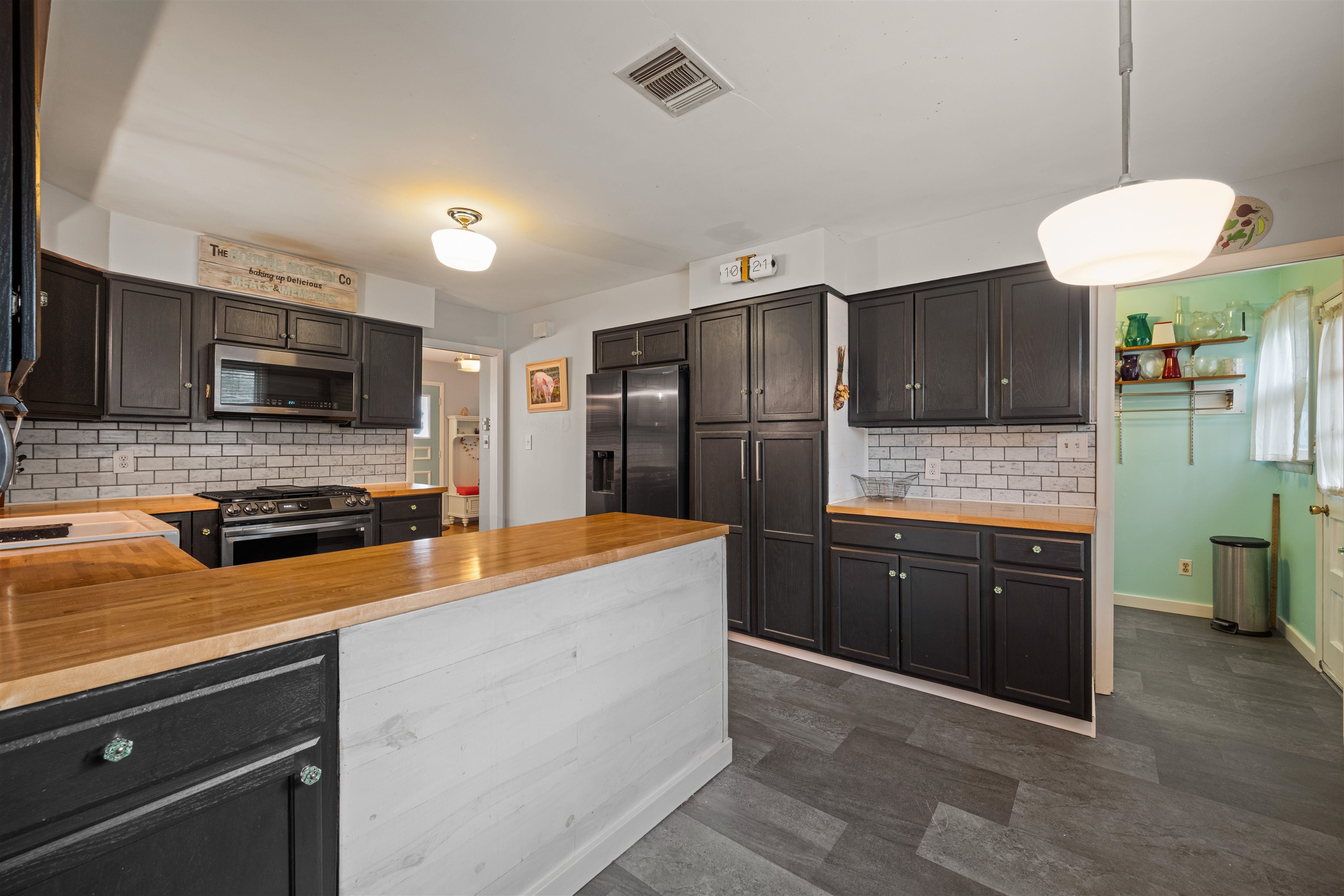 331 Holly Lane Erma, NJ 08204 - Photo 27 of 42 a kitchen with stainless steel appliances granite countertop a refrigerator a stove a sink dishwasher and wooden cabinets with wooden floor