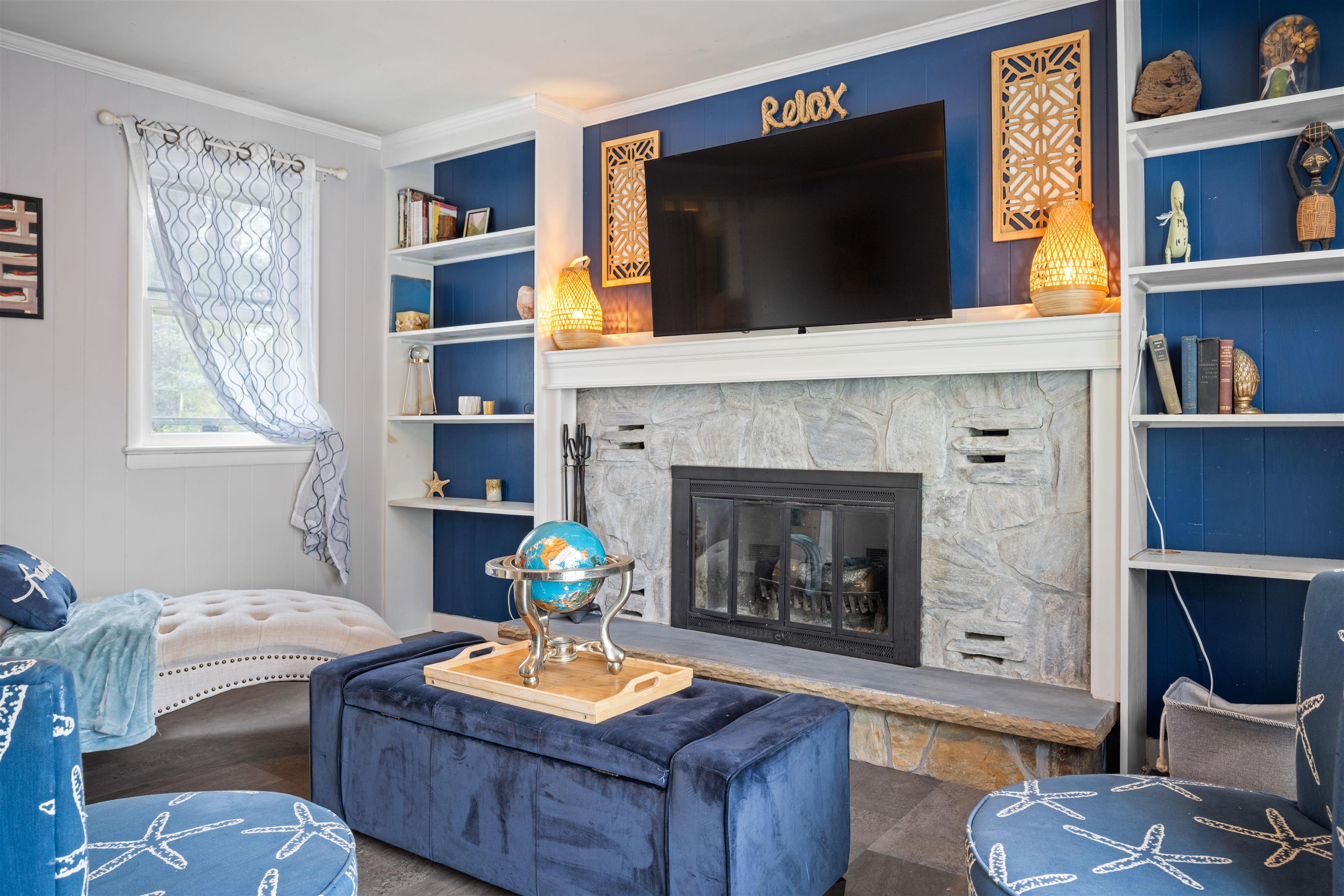 331 Holly Lane Erma, NJ 08204 - Photo 30 of 42 a living room with furniture a flat screen tv and a fireplace