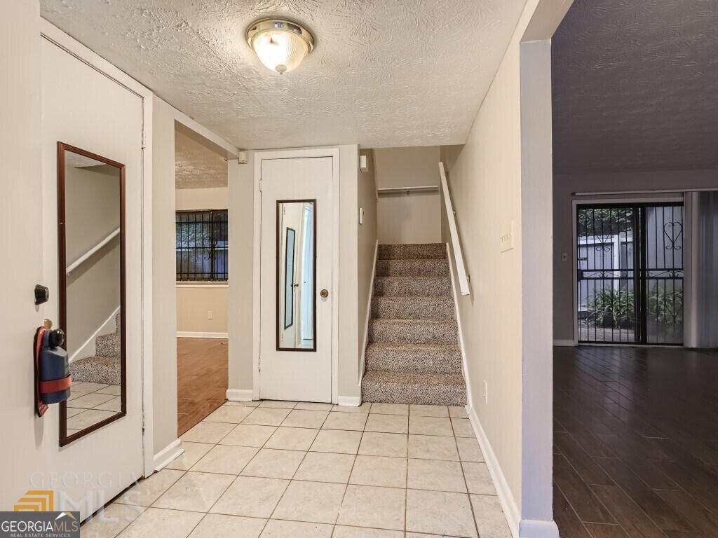 967 Pine Hollow Road Austell, GA 30168 - Photo 4 of 26 a view of a hallway with wooden floor and staircase