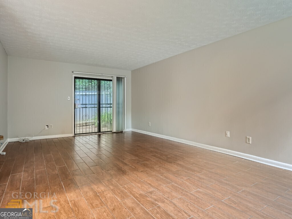 967 Pine Hollow Road Austell, GA 30168 - Photo 7 of 26 a view of an empty room with wooden floor and fan