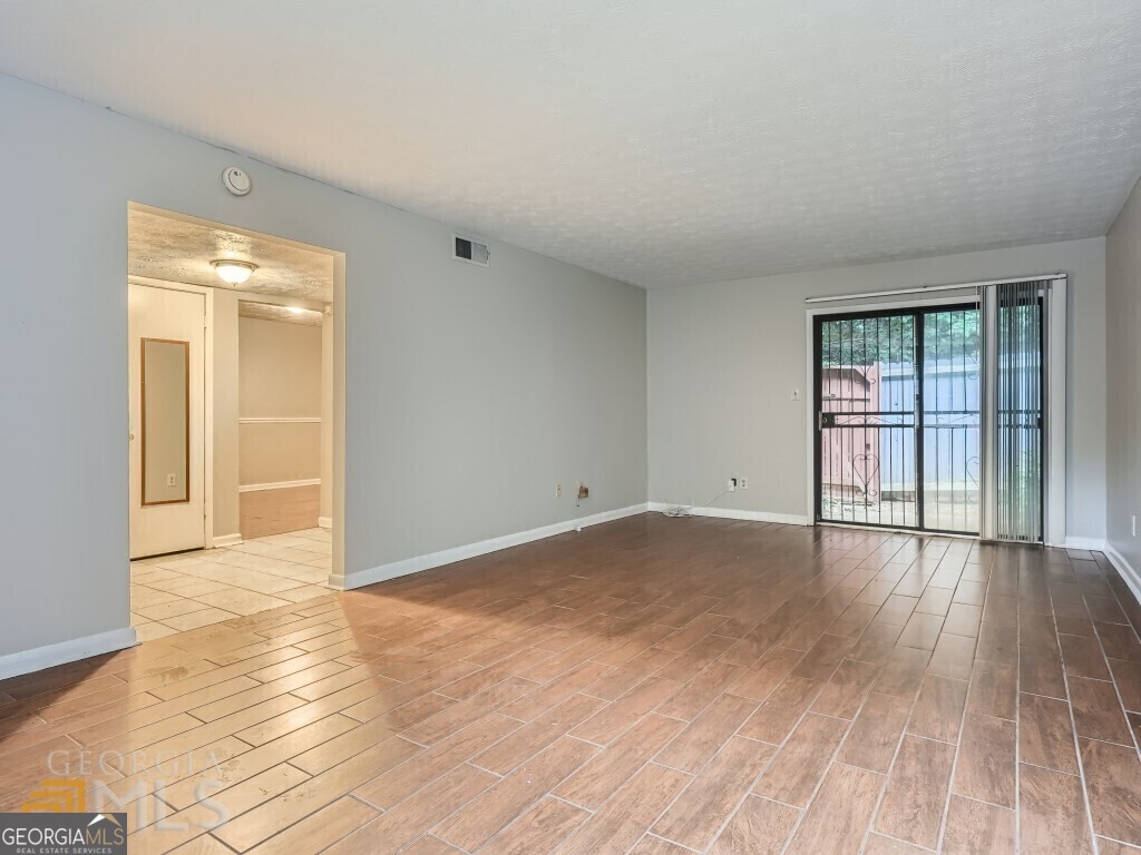 967 Pine Hollow Road Austell, GA 30168 - Photo 8 of 26 a view of an empty room with wooden floor and a window