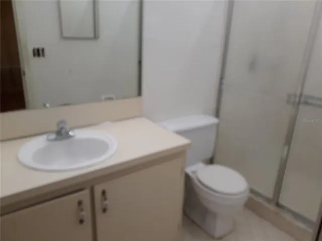 a bathroom with a sink toilet and a mirror
