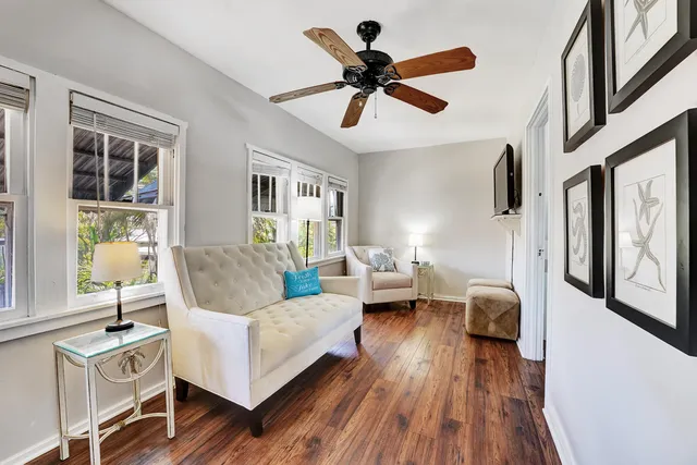 a living room with furniture and a wooden floor