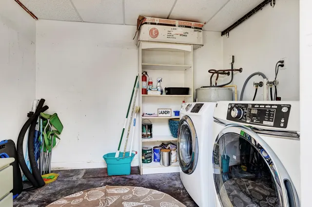 a utility room with sink dryer and washer