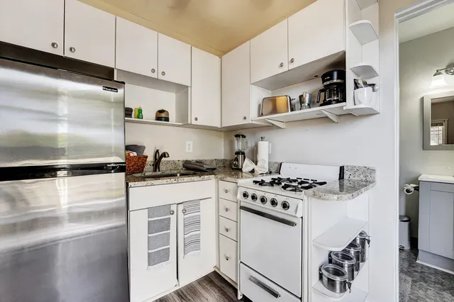 a kitchen with stainless steel appliances granite countertop a sink and a stove
