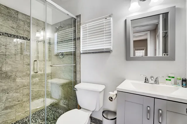 a bathroom with a sink toilet and shower