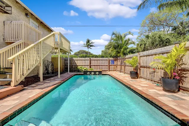 a view of yard from deck with a backyard