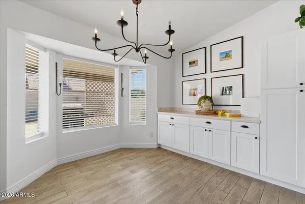 a view of a kitchen with a sink cabinet and refrigerator