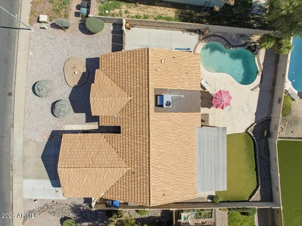 a view of a house with a backyard and a tree