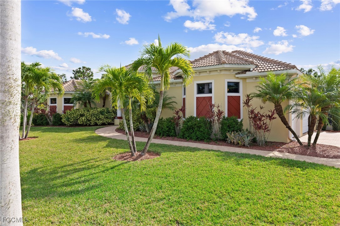 6057 Calusa Rdg Trail Bokeelia, FL 33922 - Photo 38 of 45 a house view with a garden space
