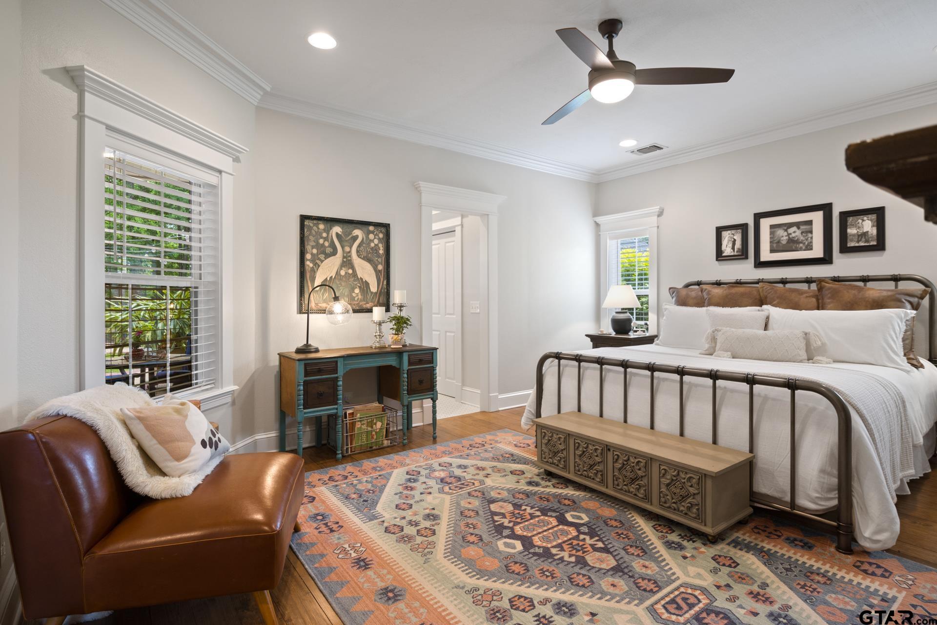 134 Private Road New Boston, TX 75570 - Photo 20 of 40 a spacious bedroom with a bed a couch and a window