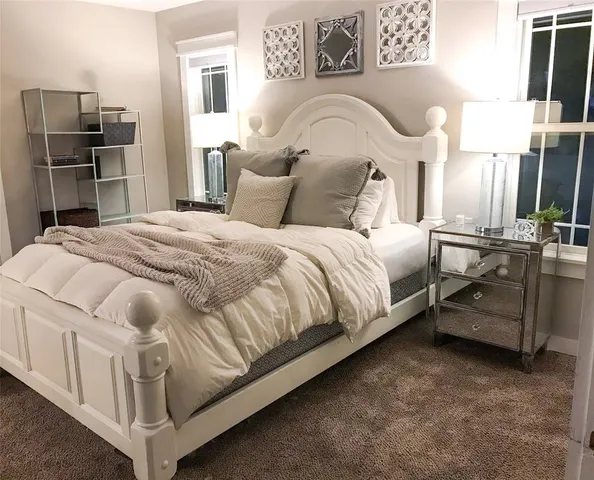 a bedroom with a bed and a television