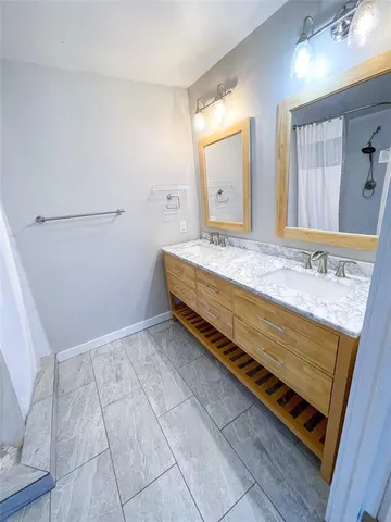 a bathroom with a sink a vanity and a mirror
