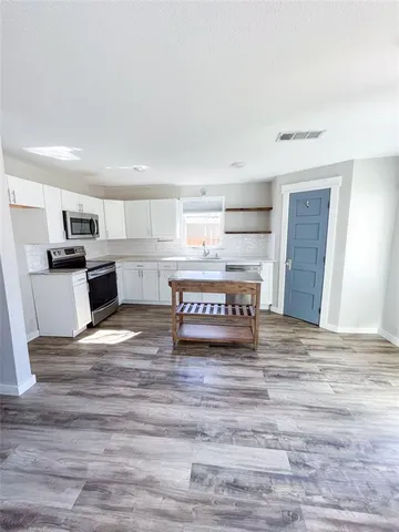 a living room with a couch and a wooden floor