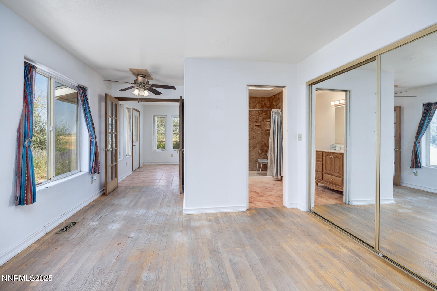 2700 Lone Tree Road Fallon, NV 89406 - Photo 8 of 24 wooden floor and windows in an empty room