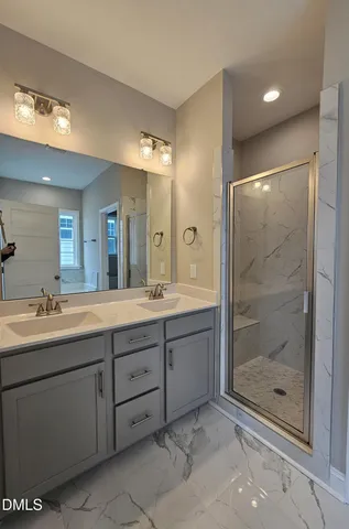 a bathroom with a shower sink and mirror