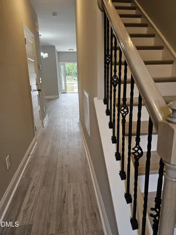 a view of an entryway with wooden floor