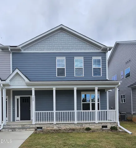 a front view of a house with a small yard