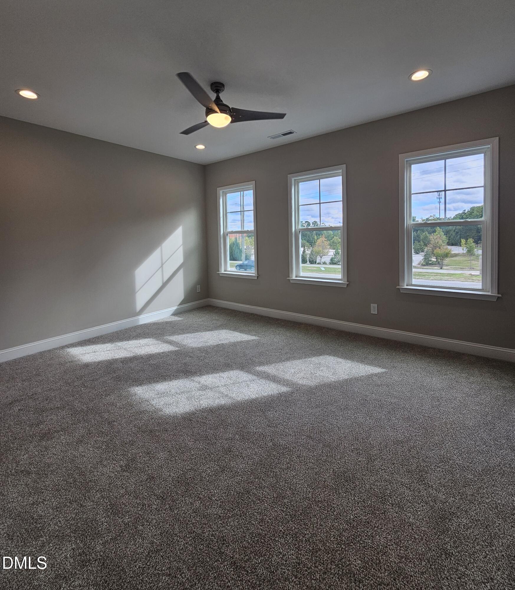 7994 Humie Olive Road Apex, NC 27502 - Photo 9 of 14 a view of room with window and ceiling fan